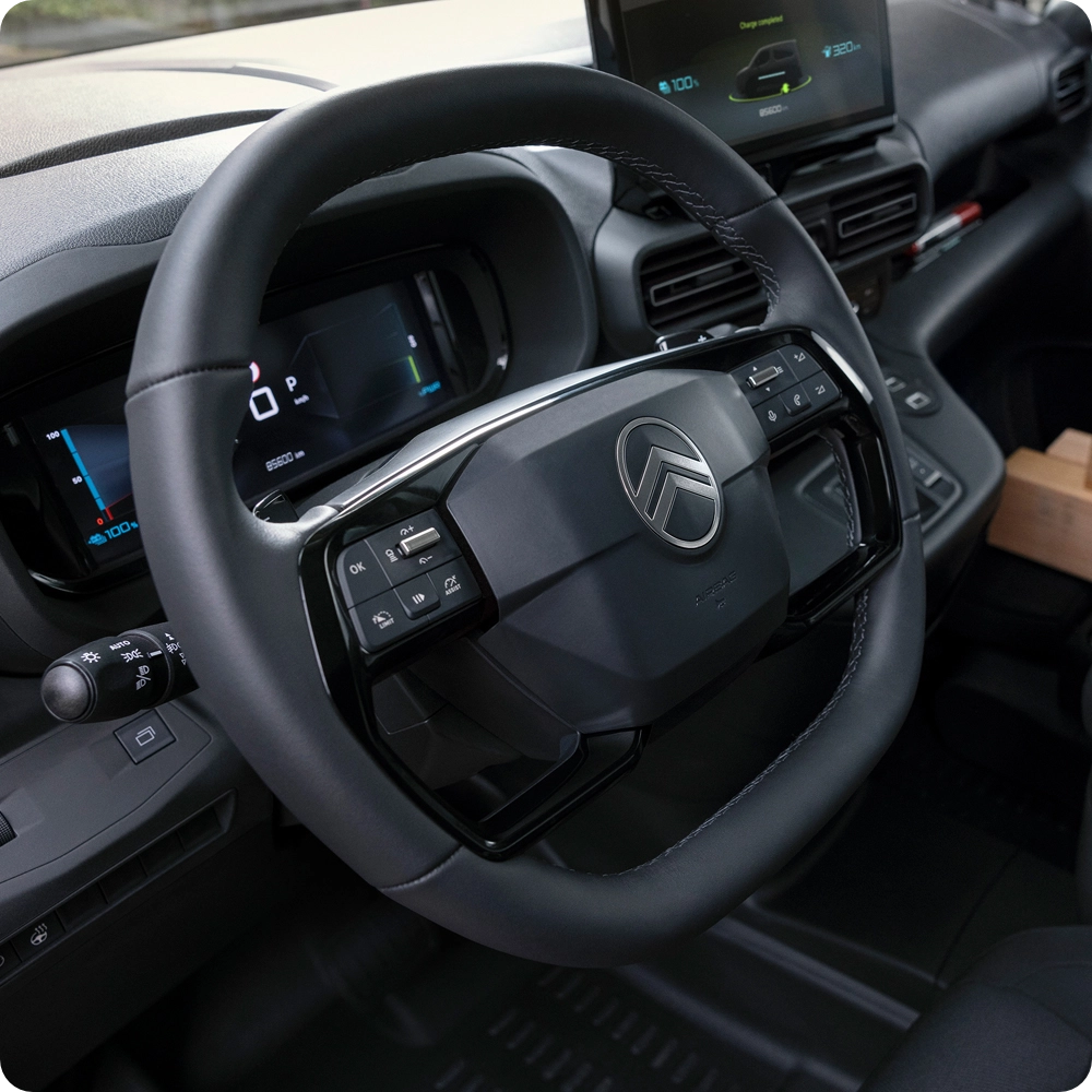 Close-up view of the Citroën ë-C3 Van charging port connected to a charging cable, highlighting convenient electric charging and zero-emission mobility.