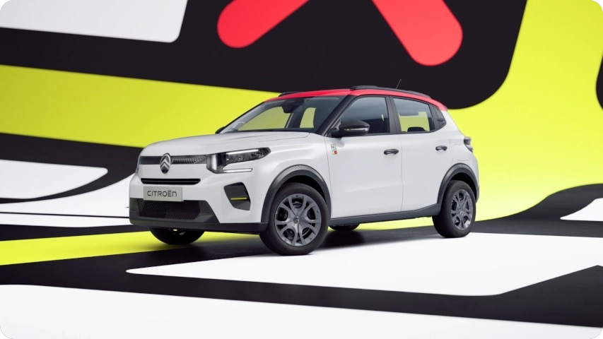 Vue avant trois quarts de la Citroën ë‑C3 TONIC, série spéciale, citadine électrique aux couleurs affirmées et au design urbain, une alternative électrique intelligente.